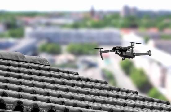 Drone over a tiled rooftop surveying for thermal anomalies